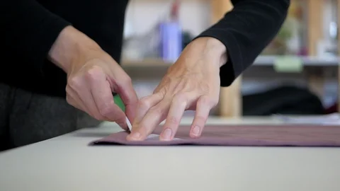 Sewing process. Tailor cutter draws a chalk pattern on fabric Stock Footage 95793794