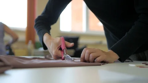 Sewing process. Tailor cutter draws a chalk pattern on fabric Stock Footage 95793899