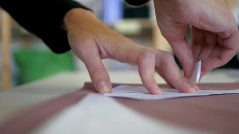Sewing process. Tailor cutter draws a chalk pattern on fabric Stock Footage 95794013