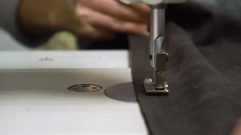 In the Sewing Process, there is a focus on Tailoring with Precision using a Stock Footage 310260318
