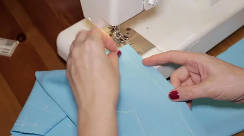 Sewing Process - Women's hands behind her sewing Stock Footage 56057135