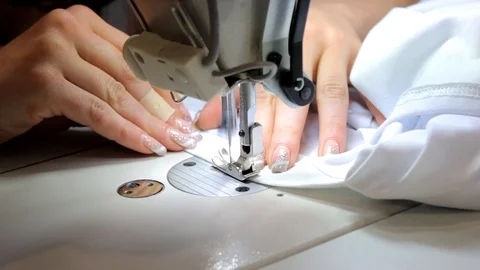 Sewing Process - Women's hands behind her sewing Stock Footage 99937345