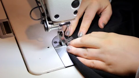 Sewing Process - Women's hands behind her sewing Stock Footage 99937352