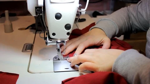 Sewing Process - Women's hands behind her sewing Stock Footage 99937362