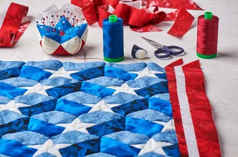 Sewing of quilt with stylized elements of American flag Fotos Stock