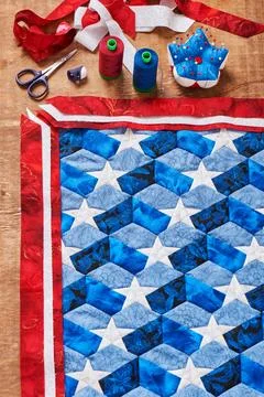 Sewing of quilt with stylized elements of American flag Stock Photos