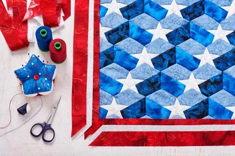 Sewing of quilt with stylized elements of American flag Fotos de archivo