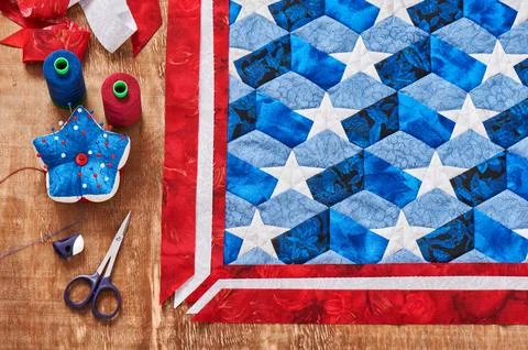 Sewing of quilt with stylized elements of American flag Stock Photos