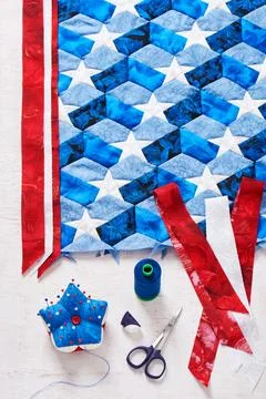 Sewing of quilt with stylized elements of American flag Stock-Fotos