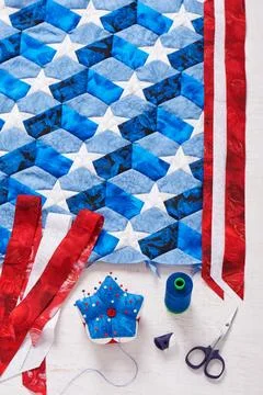 Sewing of quilt with stylized elements of American flag Stock Photos