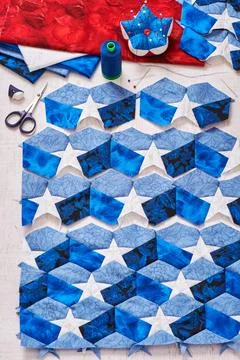 Sewing of quilt with stylized elements of American flag Fotos de archivo