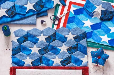 Sewing of quilt with stylized elements of American flag Fotos de archivo