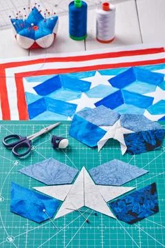 Sewing of quilt with stylized elements of American flag 스톡 사진