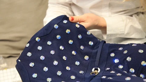 Sewing on rhinestones Stock Footage 128813387