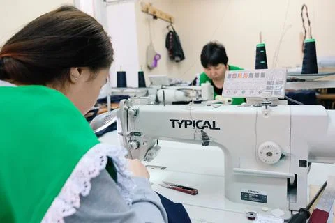 Sewing school uniforms Stockfoto's