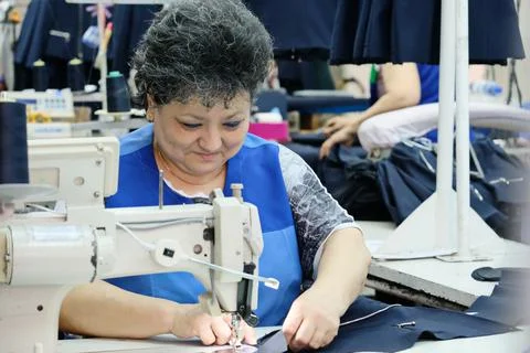 Sewing school uniforms Fotos de archivo