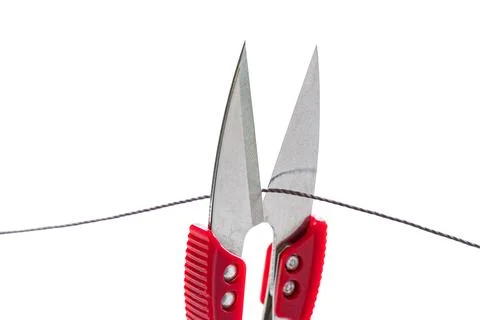 Sewing scissors cutting thread on white isolated Stock Photos