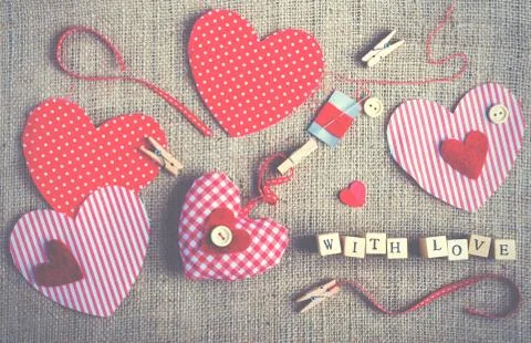 Sewing set: fabrics, threads, pins, buttons, tape and handmade hearts on burlap Stock Photos