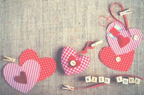 Sewing set: fabrics, threads, pins, buttons, tape and handmade hearts on burlap Stock Photos