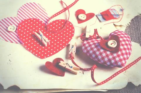 Sewing set: fabrics, threads, pins, buttons, tape and handmade hearts on burlap Stock Photos