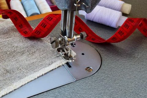 Sewing on a sewing machine. Alteration, hemming, industrial concept of handma Stock Photos