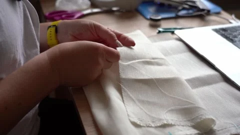 Sewing a simple fabric project at the kitchen table with personal touches Stock Footage 317999221