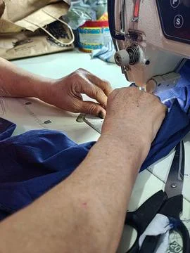 Sewing with skillful hands Stock Photos
