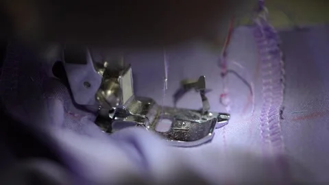 Sewing a smooth hem on a purple fabric Stock Footage 320346442