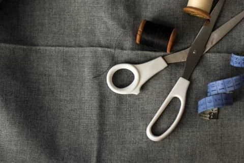 Sewing. Spools of thread on the fabric. Threads. Meter and scissors Stock Photos