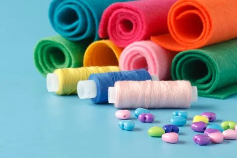 Sewing supplies, colored threads, colored pieces of cloth, needles, tailors.. Stock Photos