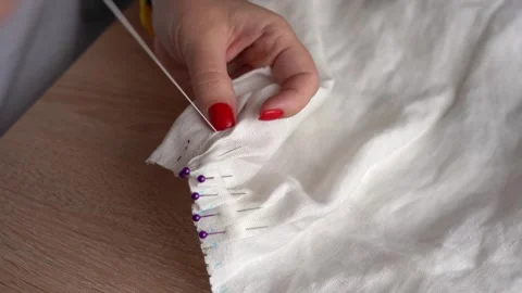 Sewing techniques for beginners in home crafting with fabric and pins Stock Footage 314653780