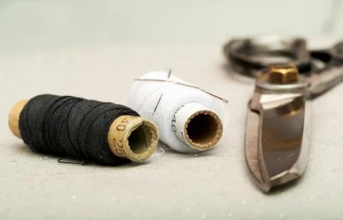 Sewing textile or cloth. Work table of a tailor. Scissors reel  thread, and Stock Photos