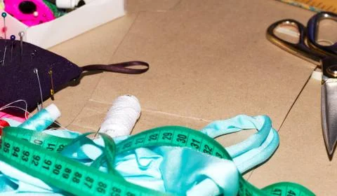 Sewing textile or cloth. Work table of a tailor. Scissors, measuring tapes Stock Photos