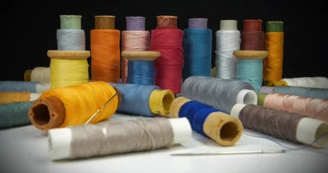 Sewing. Textile production. Many coloured  spools of threads Stock Footage 321559680