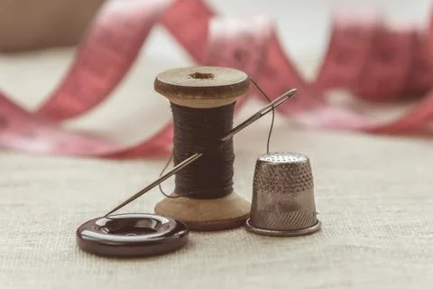 Sewing thread and for knitting? the gray thread and the needle and the button Stock Photos