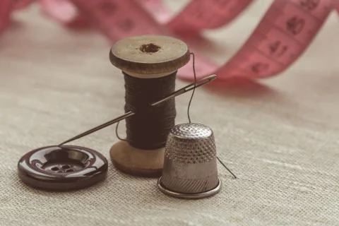 Sewing thread and for knitting? the gray thread and the needle and the button Stock Photos