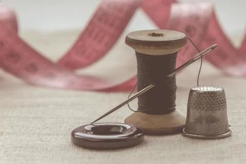 Sewing thread and for knitting? the gray thread and the needle and the button Stock Photos