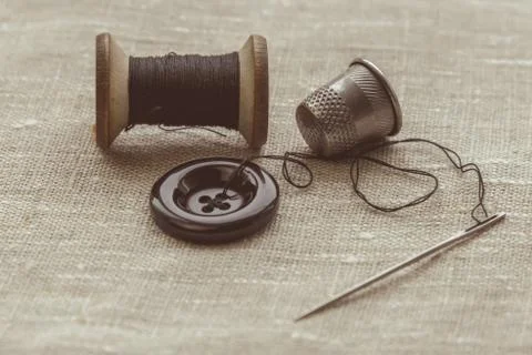 Sewing thread and for knitting? the gray thread and the needle and the button Stock Photos