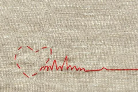 Sewing thread and for knitting, a red string in the form of a medical heart o Stock Photos