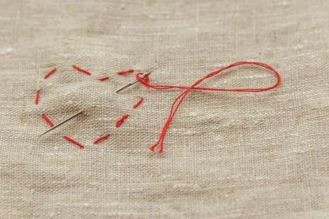 Sewing thread and for knitting the red thread is looped Stock Photos
