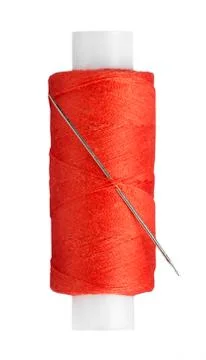 Sewing thread and needle closeup Stock Photos