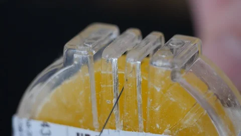 Sewing thread &amp; bee wax. Waxing makes thread stiffer, more water and mildew Stock Footage 128136287