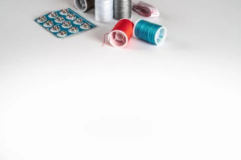 Sewing thread bobbins on the white background. Closeup. Stock-Fotos