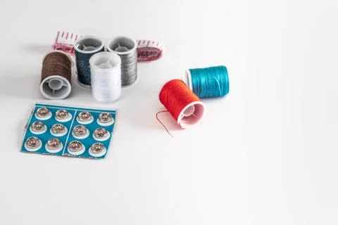 Sewing thread bobbins on the white background. Closeup. Stock-Fotos