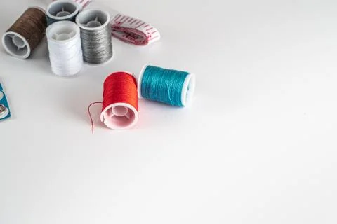 Sewing thread bobbins on the white background. Closeup. Stock Photos
