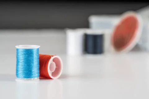 Sewing thread bobbins on the white background. Closeup. Stock Photos