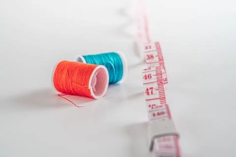 Sewing thread bobbins on the white background. Closeup. Stock Photos
