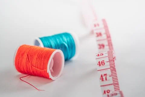 Sewing thread bobbins on the white background. Closeup. Stock-Fotos