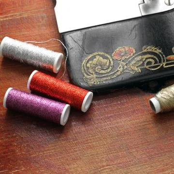 Sewing thread near the sewing machine Stock Photos