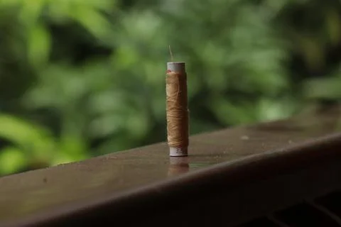 A sewing thread placed on a dusty floor Stock Photos